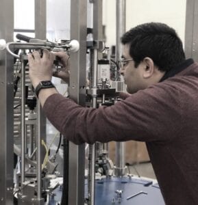 an engineer carrying out a machine repair to a filling machine