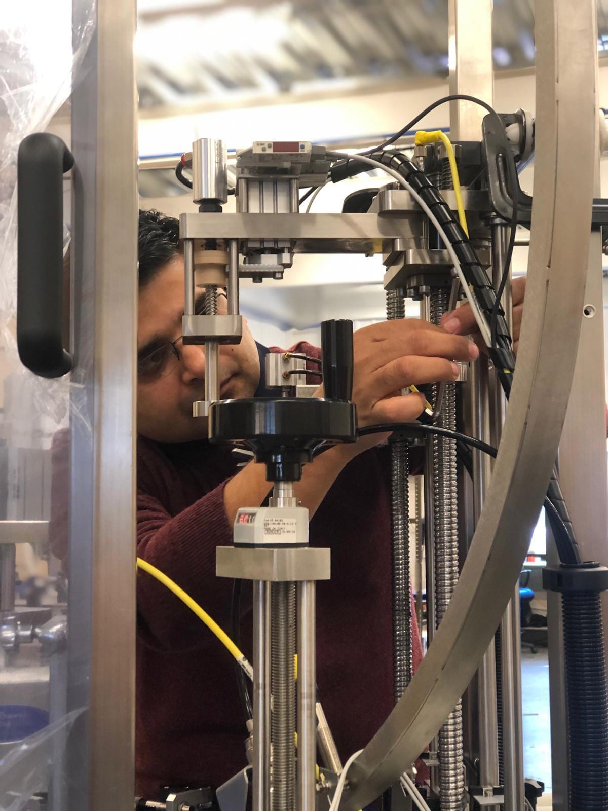 An Adelphi engineer assessing a filling machine for refurbishment