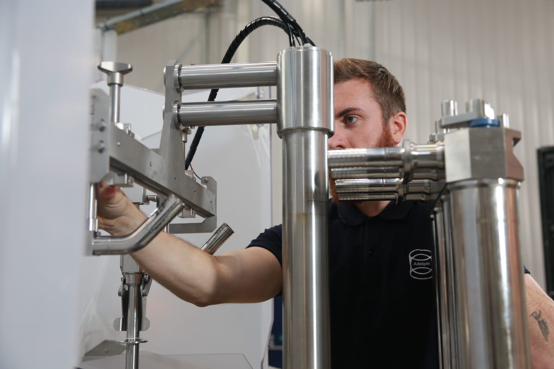 Adelphi engineer carrying out machine maintenance on filling machine